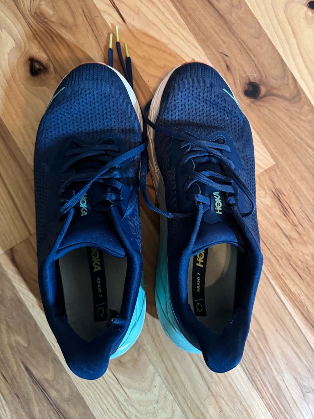 Hoka One One navy blue sneakers with aqua insole accents